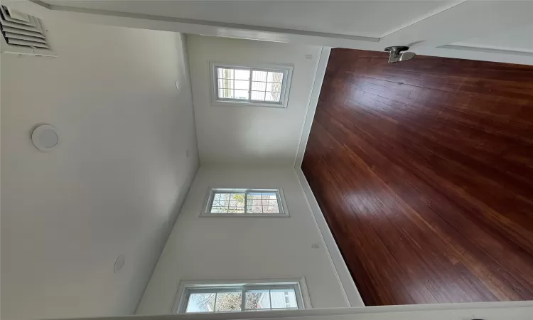 Spare room with dark wood-type flooring, recessed lighting, and baseboards