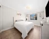 Bedroom featuring ornamental molding and light hardwood / wood-style flooring