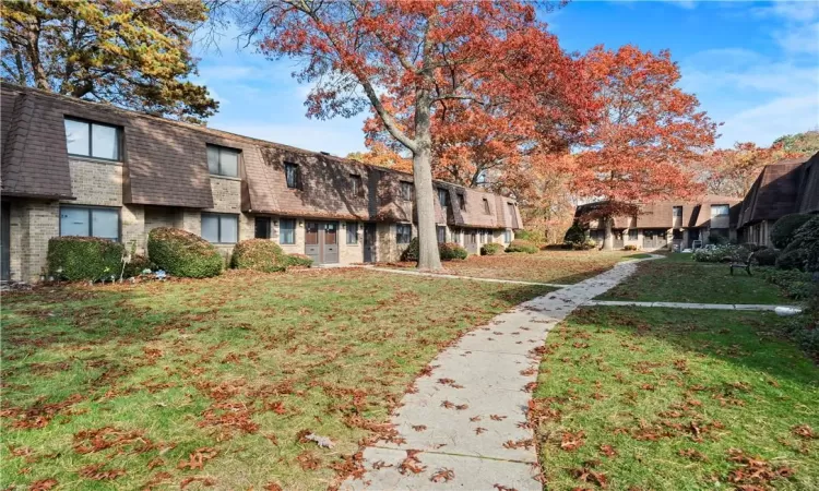 View of home's community with a yard