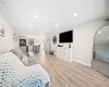 Living room featuring light hardwood / wood-style floors and crown molding