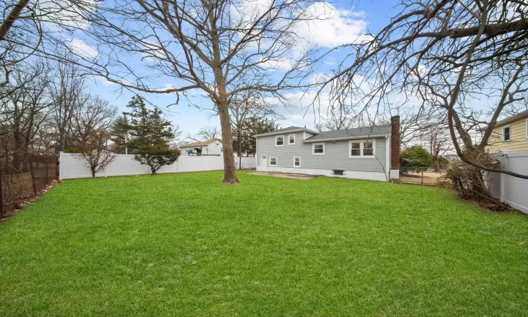 View of yard featuring a fenced backyard and a patio