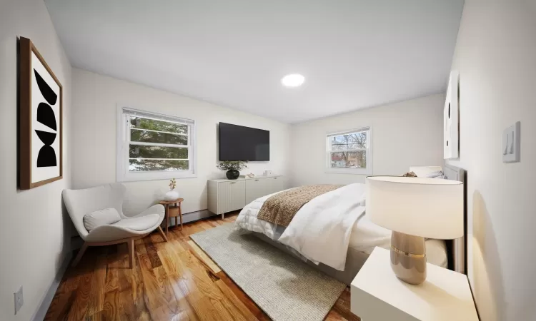 Bedroom featuring baseboards and wood finished floors