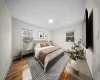 Bedroom featuring baseboards, multiple windows, and light wood finished floors