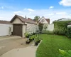 View of yard with concrete driveway, fence, a detached garage, and an outdoor structure