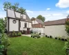 Back of house featuring fence, a yard, roof with shingles, stucco siding, and a patio area