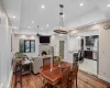 Dining area with a fireplace, wood finished floors, a ceiling fan, and recessed lighting