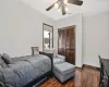 Bedroom featuring a closet, visible vents, a ceiling fan, wood finished floors, and baseboards