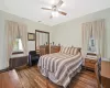 Bedroom with a closet, radiator, visible vents, and wood finished floors