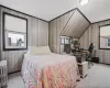 Bedroom with radiator, wooden walls, baseboards, and carpet flooring