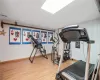 Workout room with visible vents, baseboards, and wood finished floors