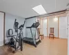 Exercise room featuring visible vents, baseboards, and wood finished floors