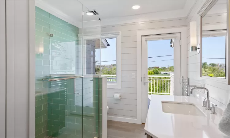 Brand new Bathroom as of 2024 featuring towel warmer, radiant heated floors, and custom built linen cabinetry, gorgeous single vanity, and a custom cut glass shower with hand sprayer