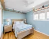 Bedroom 3 with raised shelving, a custom collectors cabinet, and plenty of natural light, ceiling fan with light