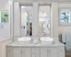 Full bathroom featuring double vanity and a sink