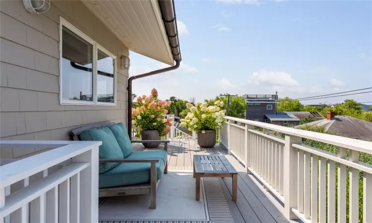 Second Floor deck with access to upstairs hall bathroom as well as second bedroom, one way glass skylight through to screened in porch below