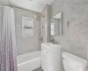 Full bath featuring shower / bath combination with curtain, toilet, tile walls, and vanity