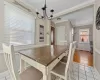 Dining room with ornamental molding, baseboards, an inviting chandelier, and light tile patterned floors