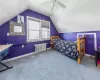 Bedroom with carpet floors, radiator heating unit, vaulted ceiling, ceiling fan, and baseboards