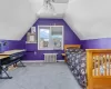 Bedroom featuring carpet floors, lofted ceiling, baseboards, and radiator heating unit