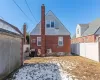 Back of property with ac unit, a chimney, brick siding, and a fenced backyard