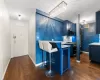 Kitchen featuring appliances with stainless steel finishes, dark wood-type flooring, a breakfast bar area, and blue cabinets