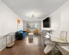 Living room featuring baseboards, hardwood / wood-style floors, and a notable chandelier