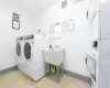 Common laundry area featuring baseboards, visible vents, separate washer and dryer, and light tile patterned flooring