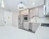 Kitchen featuring backsplash, crown molding, stainless steel appliances, and a sink