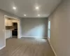 Unfurnished living room featuring light wood-type flooring, baseboards, and recessed lighting