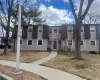 Townhome / multi-family property with a shingled roof