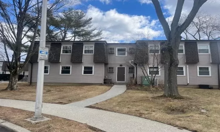 Townhome / multi-family property with a shingled roof