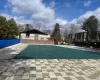 Pool featuring fence and a patio