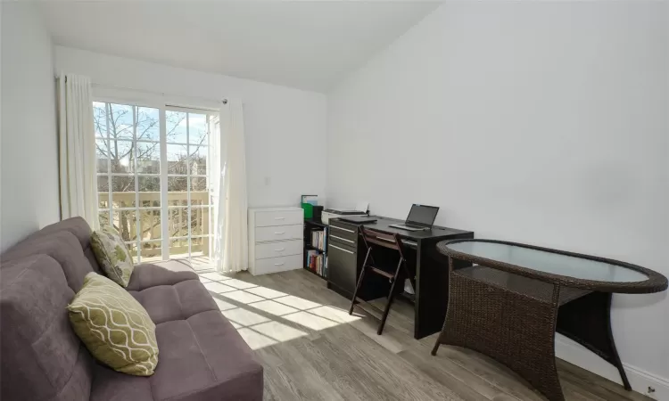 Second Bedroom with vaulted ceiling and wood finished floors