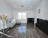 Living room with recessed lighting, visible vents, vaulted ceiling, and wood finished floors