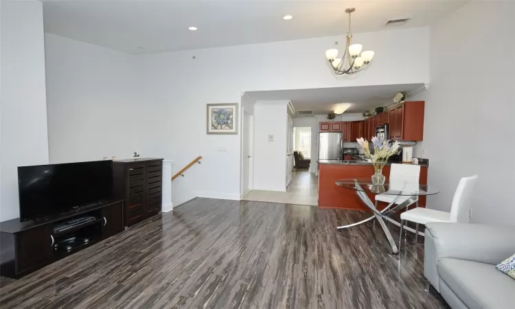 Dining area featuring recessed lighting, wood finished floors, and an inviting chandelier