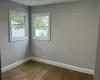 Unfurnished room with baseboards and wood finished floors