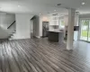 Kitchen with a healthy amount of sunlight, stainless steel refrigerator with ice dispenser, a sink, and open floor plan