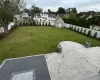 View of yard with a fenced backyard, a residential view, and an outdoor structure