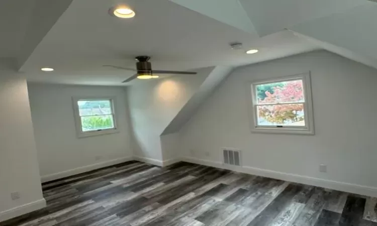 Additional living space featuring baseboards, visible vents, wood finished floors, vaulted ceiling, and recessed lighting