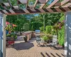 View of patio from kitchen featuring outdoor dining area, area for grilling, and a pergola