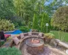 View of patio / terrace with a fire pit and an outdoor pool. Brand new.