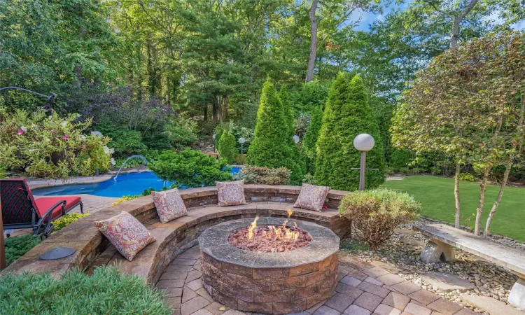 View of patio / terrace with a fire pit and an outdoor pool. Brand new.