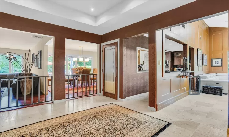 Corridor featuring baseboards, visible vents, and recessed lighting