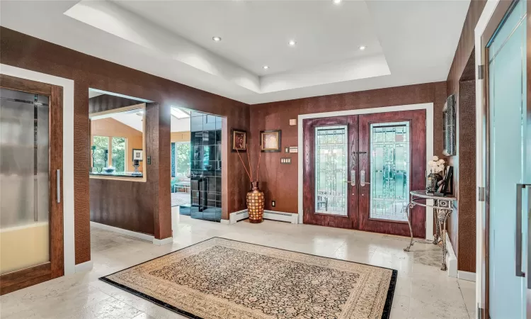 Foyer entrance featuring a tray ceiling and Central Vacuum with recessed hose.