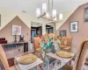 Dining space with visible vents, a notable chandelier, baseboards, and wood finished floors