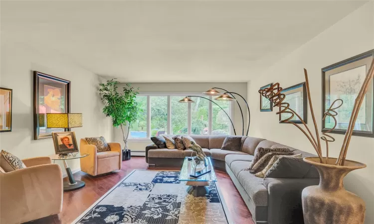 Living area featuring baseboard heating and wood finished floors