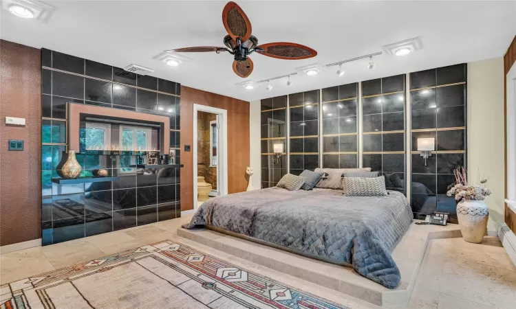 Primary bedroom is sexy and cool with fireplace and platform bed and custom walls.