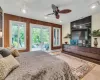 Bedroom with access to exterior, a baseboard radiator, visible vents, and a ceiling fan