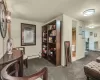 Sitting room in basement with carpet and full bath.