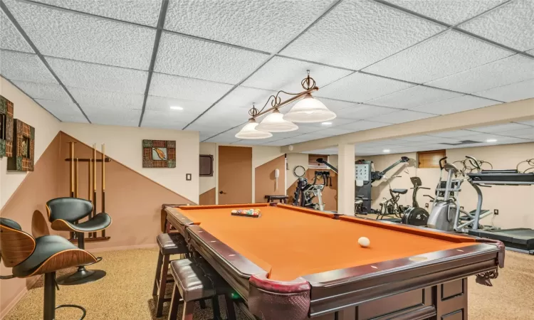 Recreation room featuring recessed lighting, carpet, a paneled ceiling, and baseboards